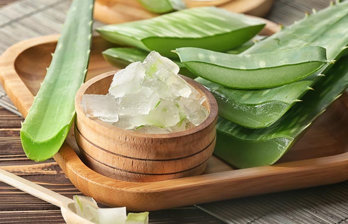 Bowl of aloe vera gel on a wooden tray
