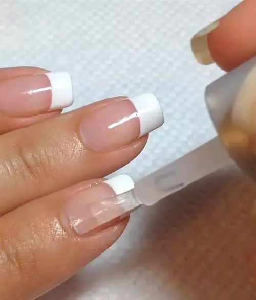 Apply a top layer of gel coat to get a French manicure