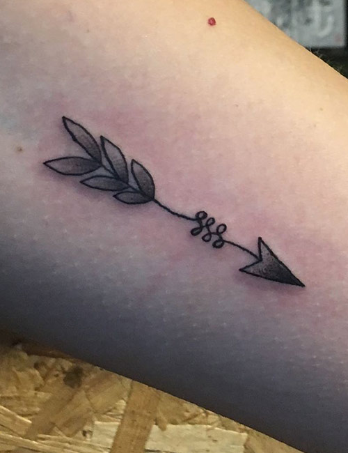 A stylized arrow tattoo