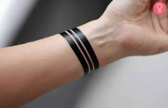 Black stripe tattoo on the wrist