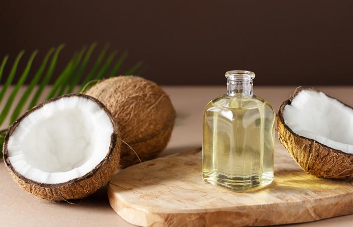 Bottle of coconut oil and coconuts