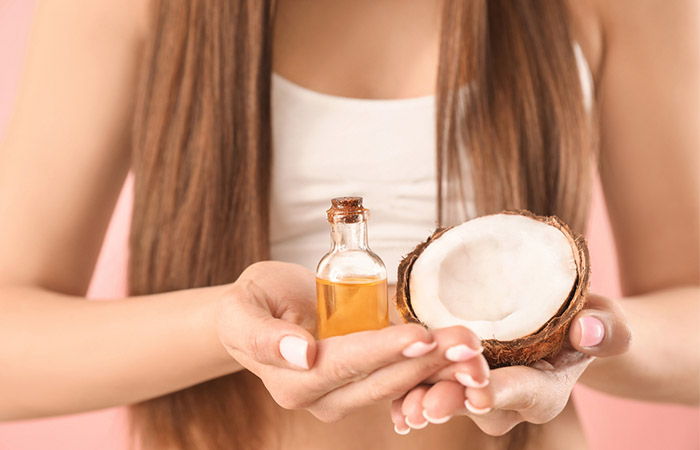 Woman with coconut and coconut oil 