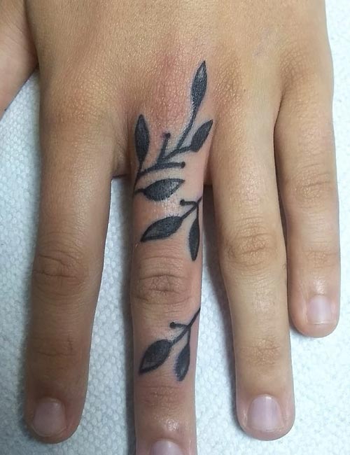 Floral tattoo on the middle finger