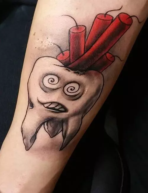 A funny tattoo of a tooth with fircrackers sticking out of it