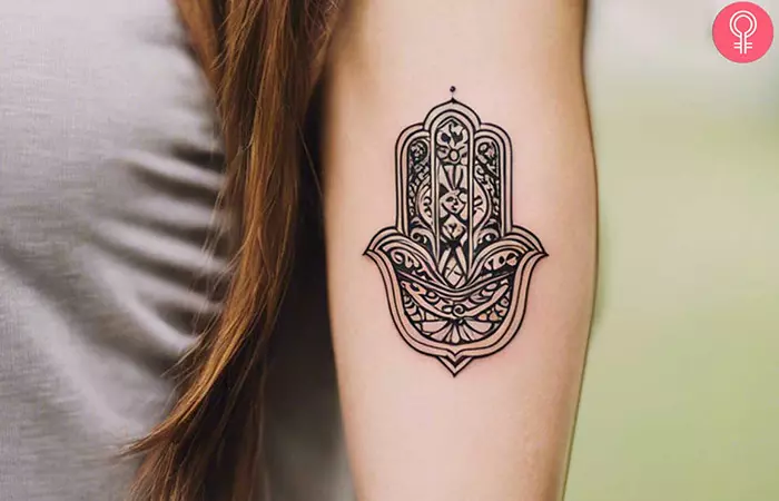 Hamsa tattoo on the arm of a woman