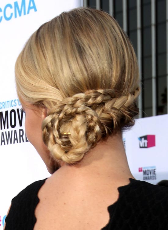 Low braid chignon as bridal hairstyle for curly hair