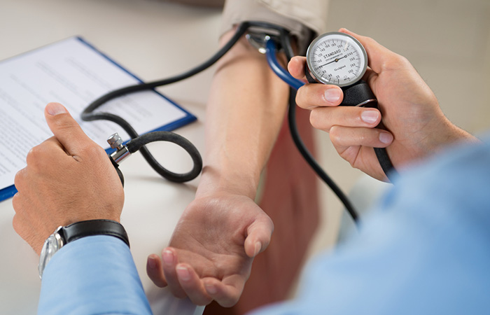 Doctor checking a patient's blood pressure level