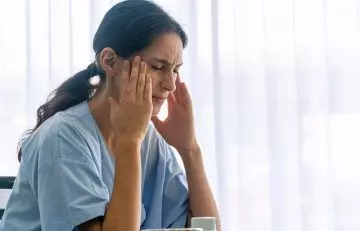 A woman experiencing migraine pain