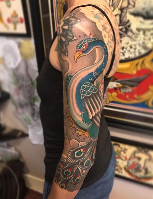 Peacock arm tattoo idea