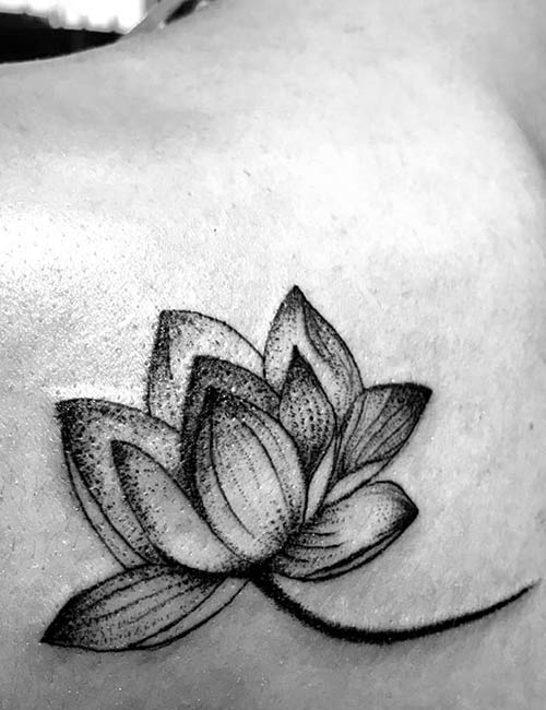 Small lotus tattoo on the upper back