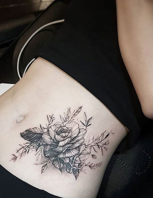 Tattoo of a rose on the waist