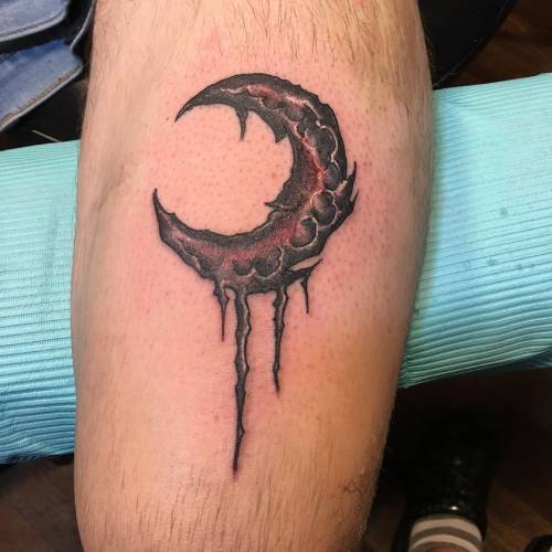 Black moon tattoo on the sleeve