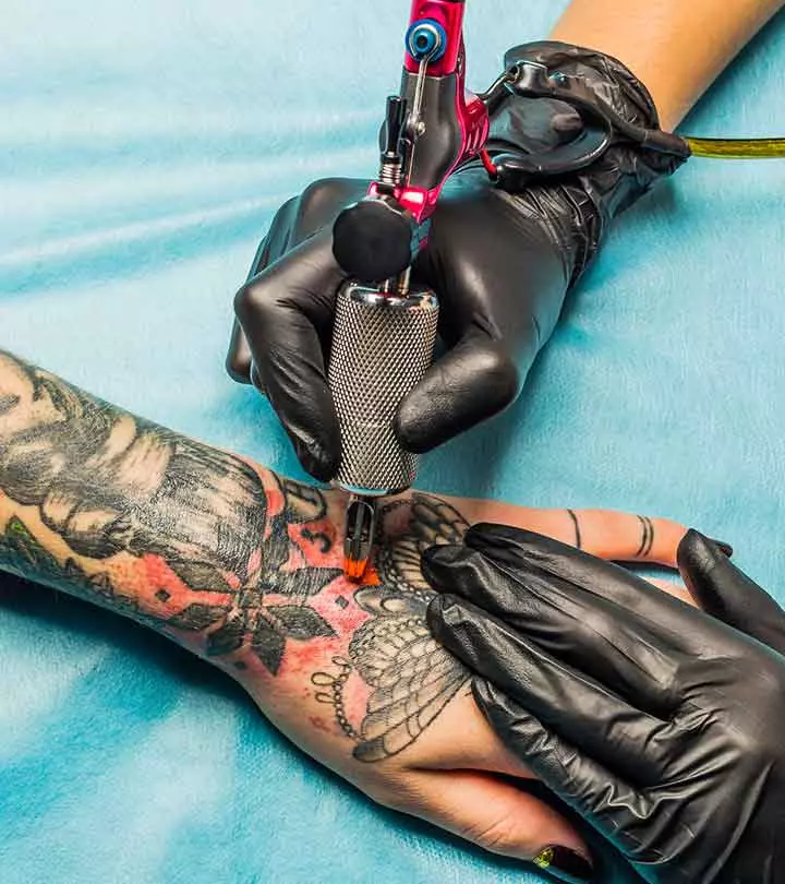 Best Places To Get Your Tattoo In Kolkata - Our Top 10 A woman with a minimalist crab tattoo on her upper arm