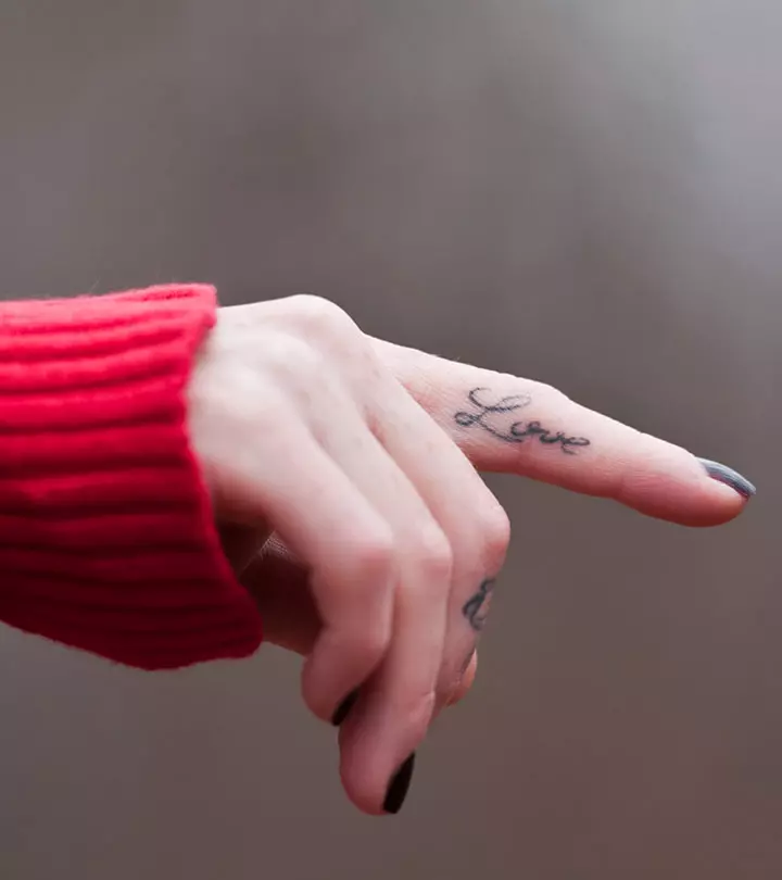 A minimalist tattoo on a woman's finger
