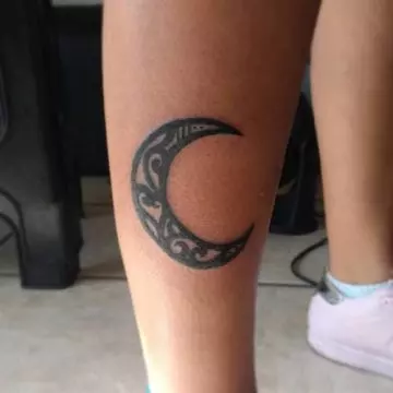Tribal moon tattoo on leg