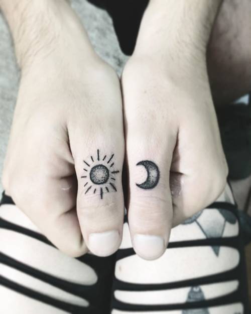 Minimal moon tattoo on a finger