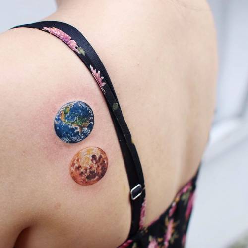 Artistic earth and moon tattoo