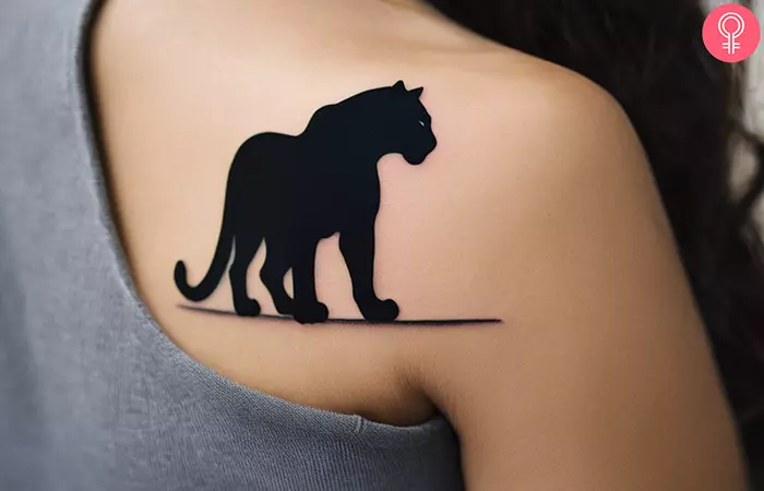 A black panther tattoo on the back of the shoulder