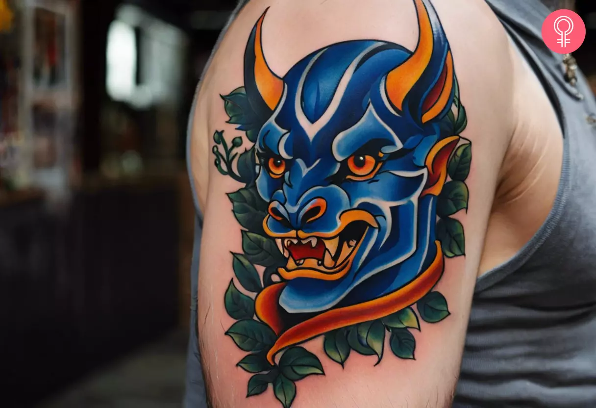 A blue devil tattoo on the upper arm