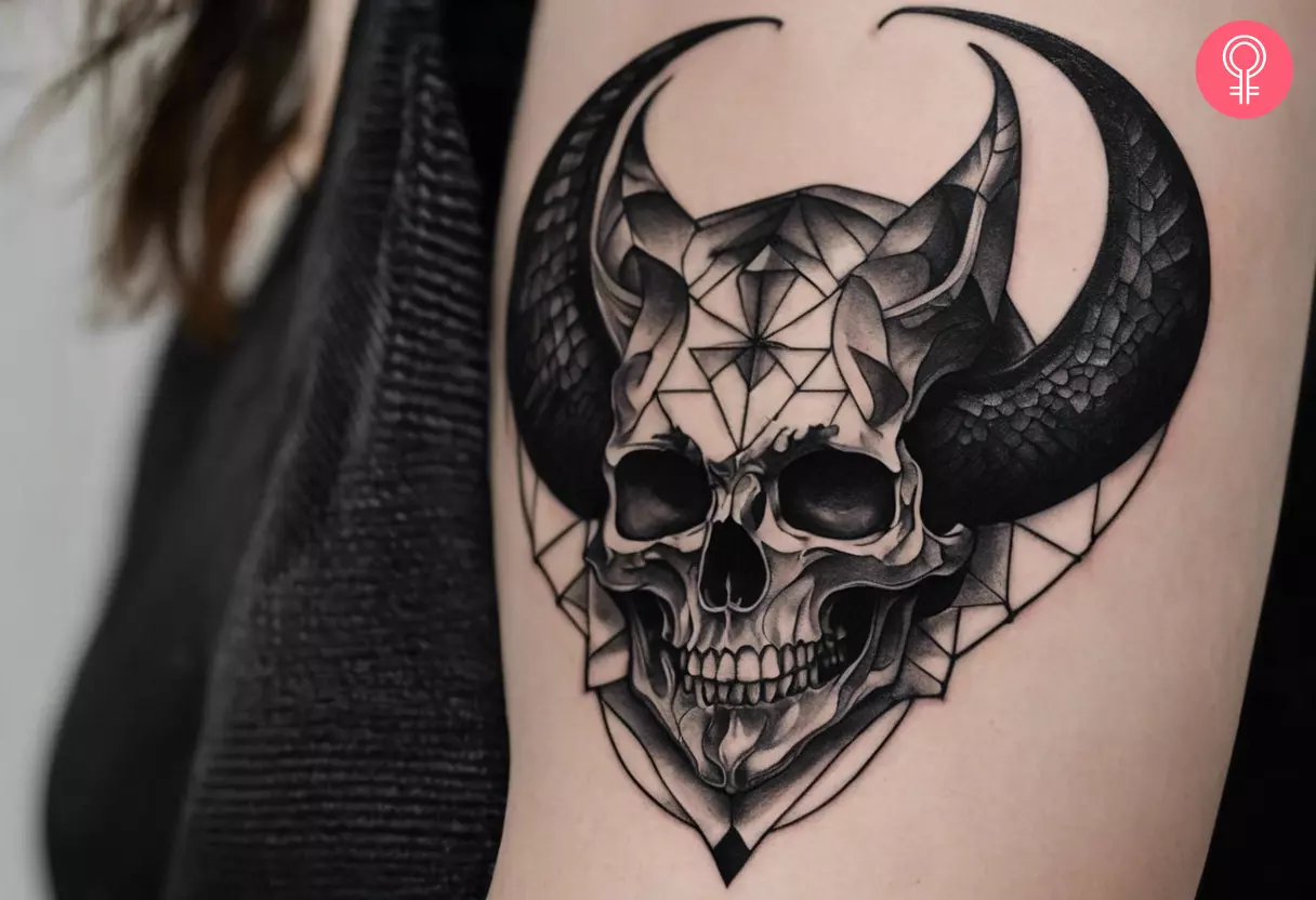 A devil skull tattoo on the upper arm