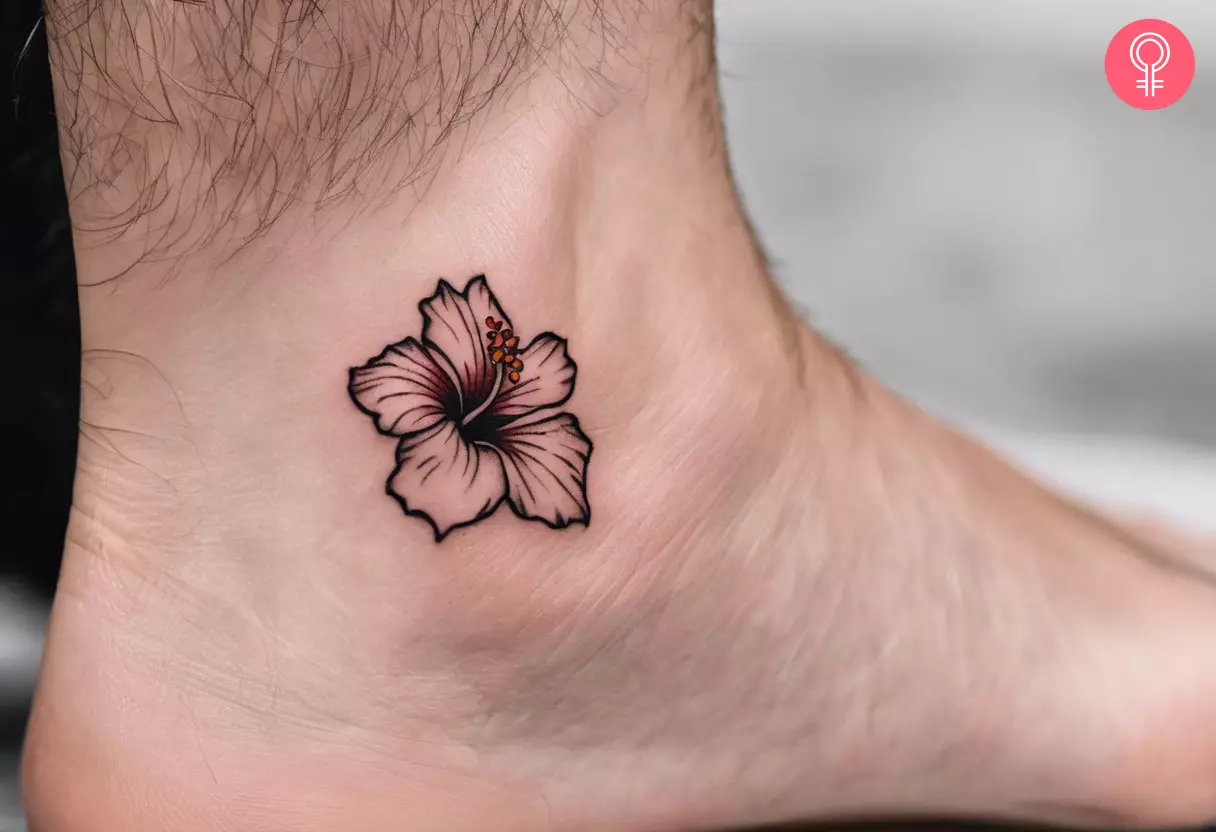 A hibiscus line tattoo on the ankle