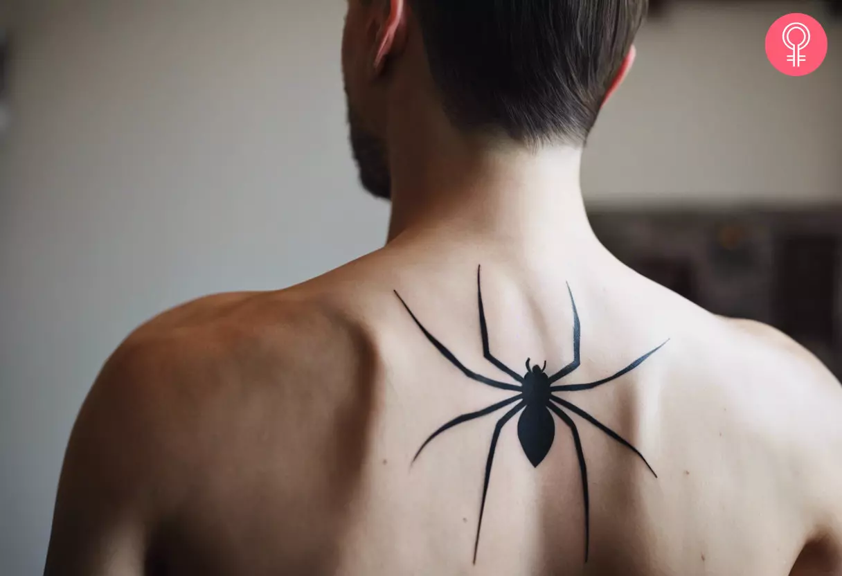 A man wearing a spider back tattoo