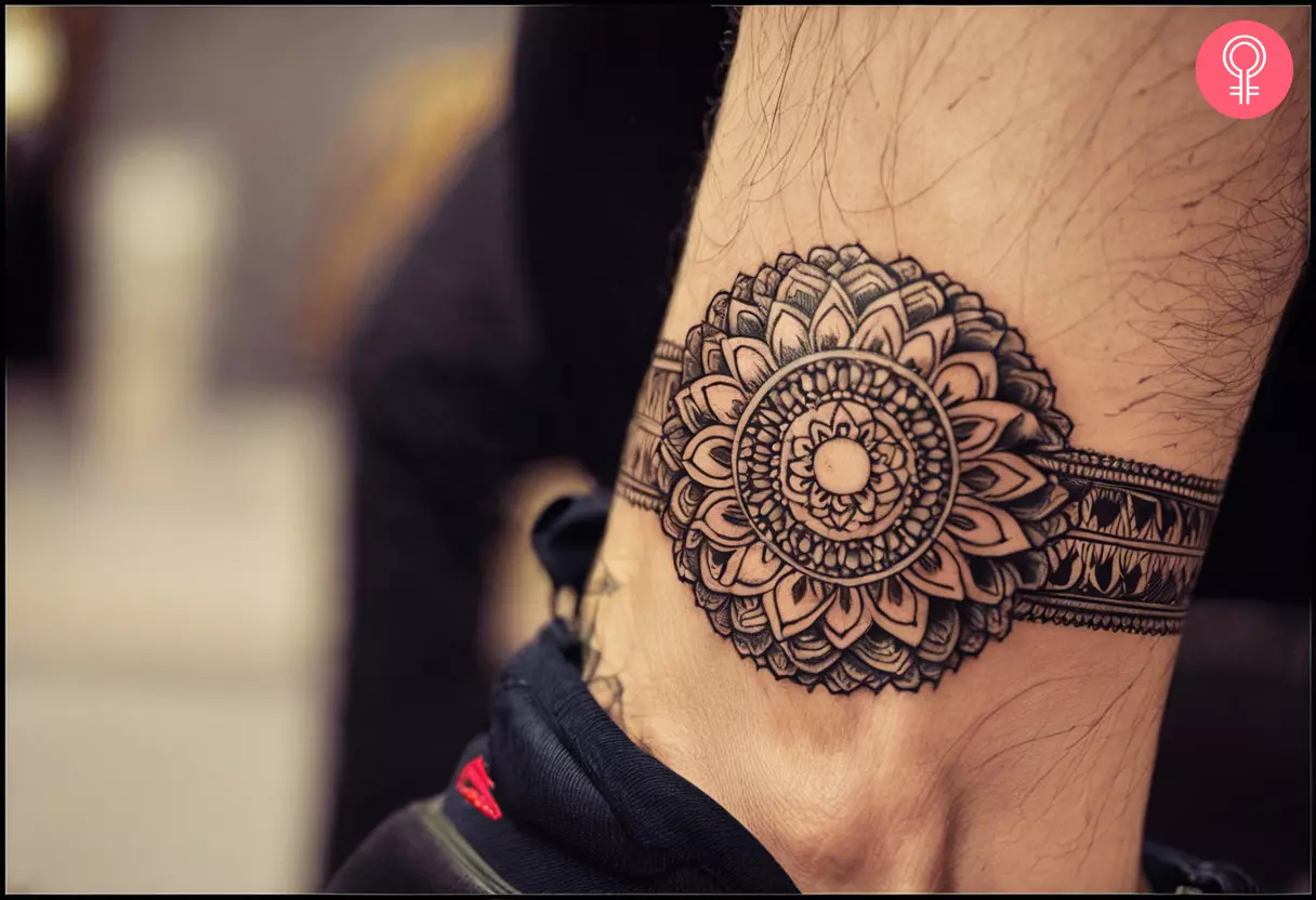 A mandala tattoo with a band that goes around the ankle