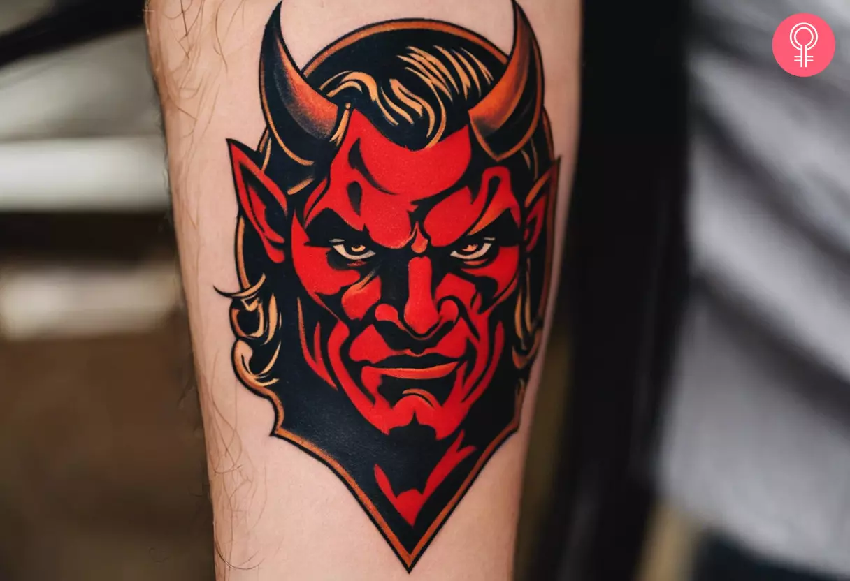 A red devil tattoo on the forearm