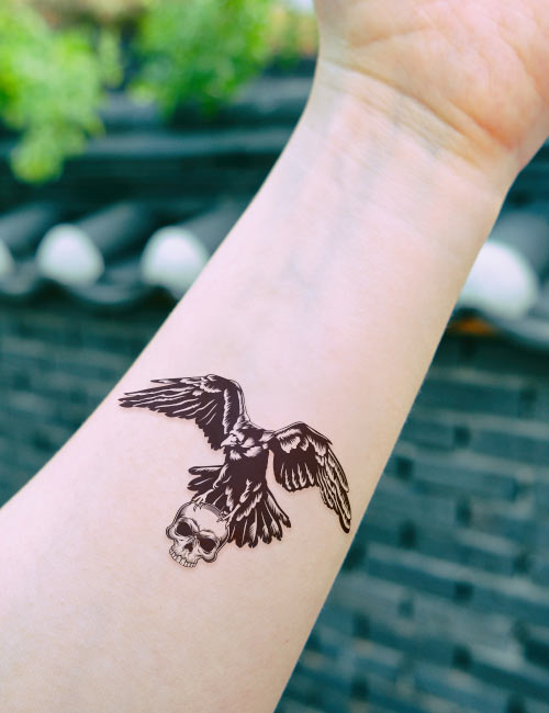 A skull and raven tattoo