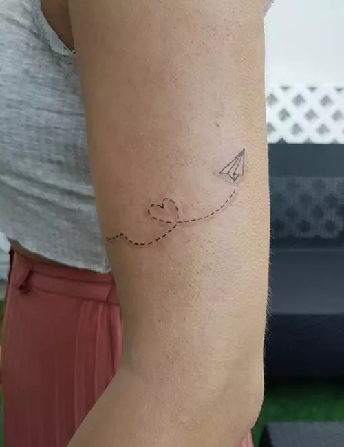 Small airplane tattoo design on hand