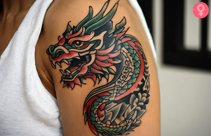 A woman with an Aztec dragon tattoo on her upper arm.