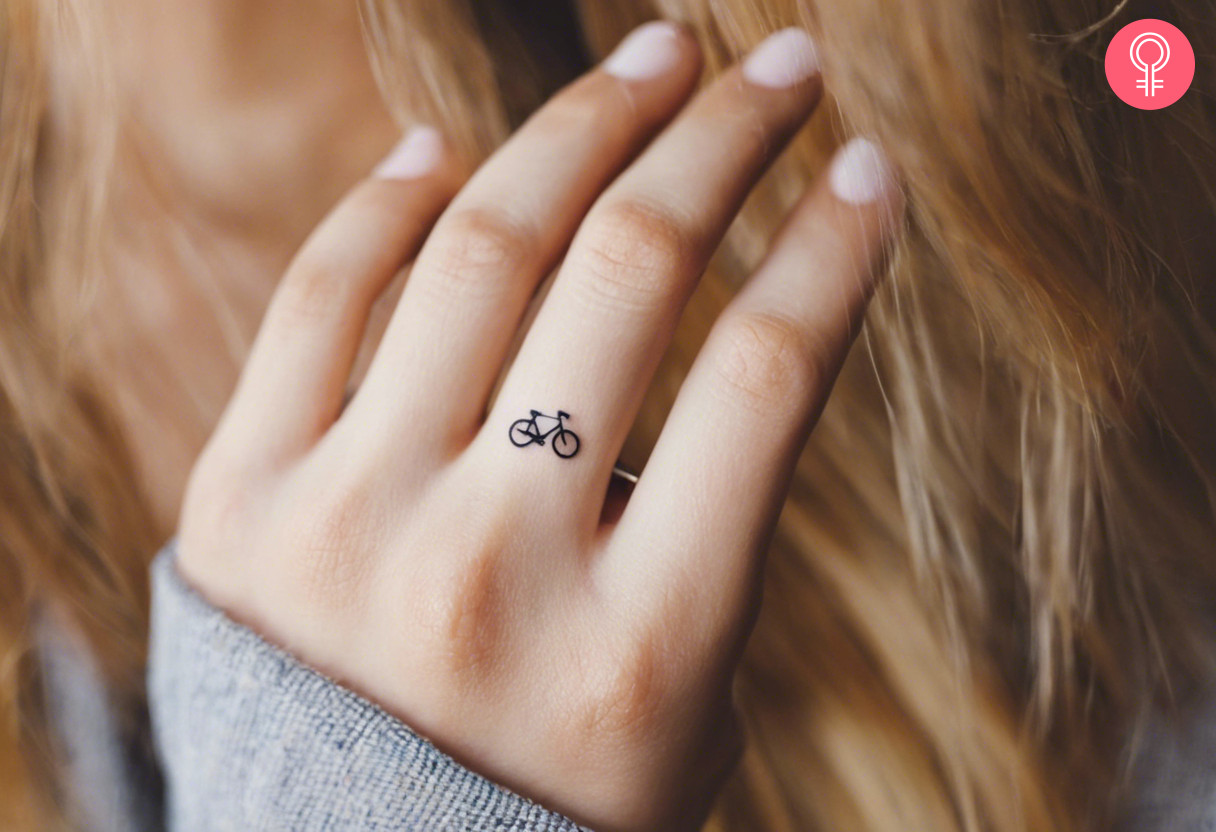 A woman with a bicycle tattoo on her finger