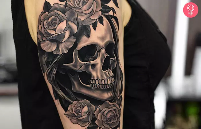 Black and gray skull tattoo on her bicep