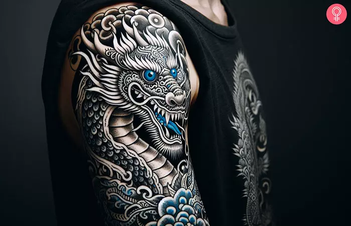 A man with a blue-eyed white dragon tattoo on his upper arm.