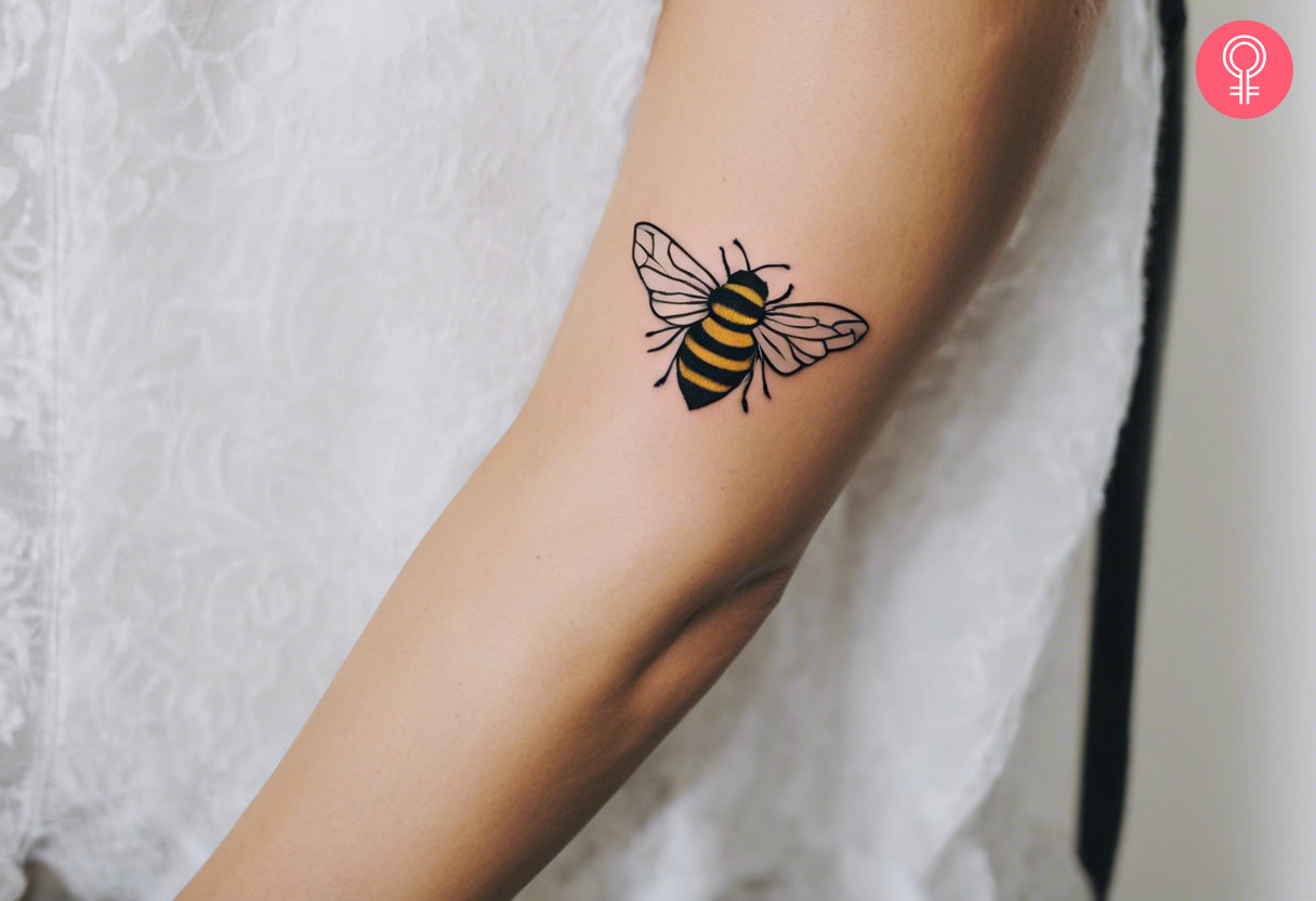 A woman with a bumblebee tattoo on her lower arm
