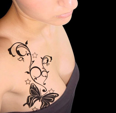 Butterfly breast tattoo