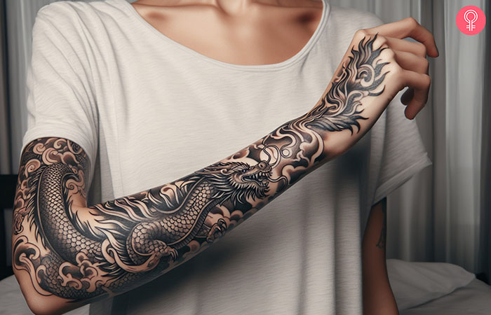 A woman with a cool black dragon tattoo on the forearm.