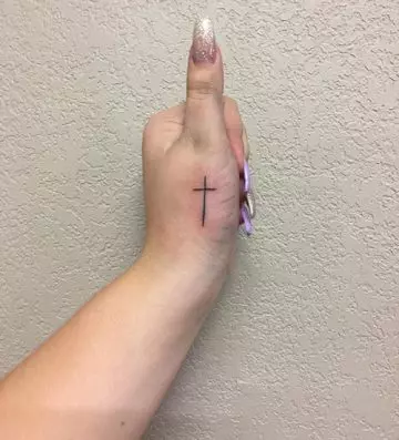 Cross tattoo on the thumb