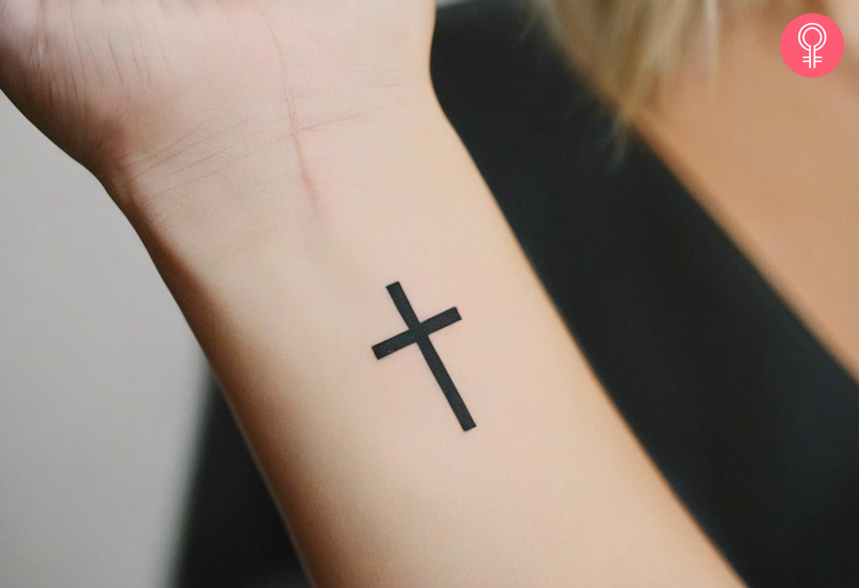 A woman with a cross tattoo on her wrist