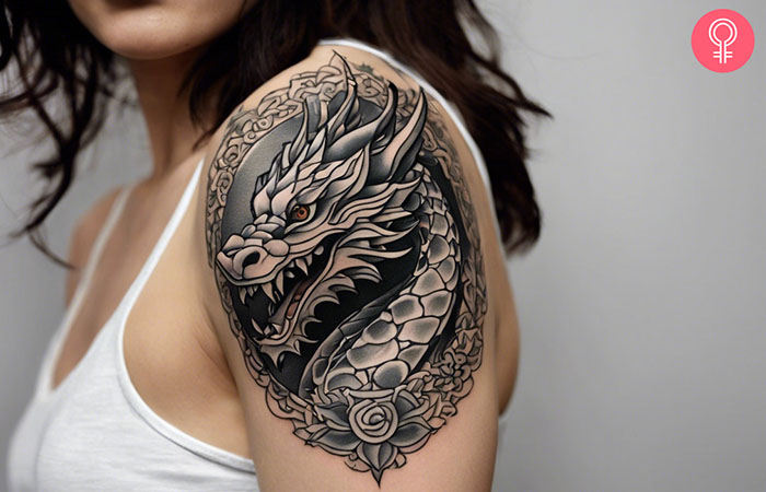 A dragon head tattoo on the upper arm.
