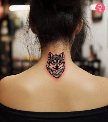 An alpha wolf tattoo on a woman’s bicep