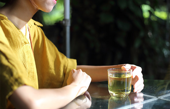 Woman drinking green tea to reduce appetite