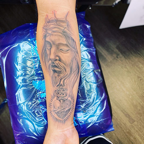 Jesus tattoo on the forearm