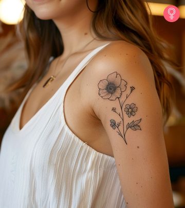 A woman with a 'live laugh love' tattoo on her upper arm