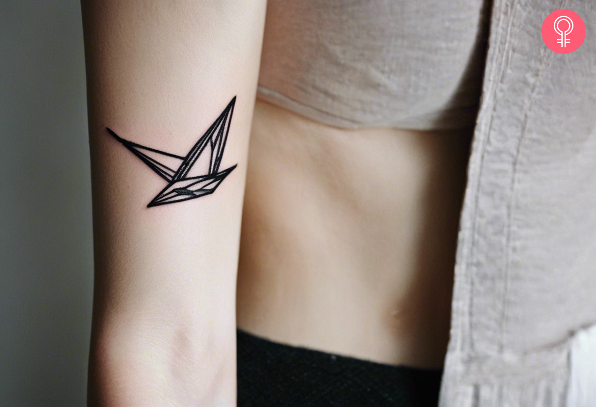 A woman with a paper crane tattoo on her outer arm