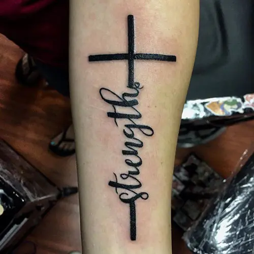 Cross tattoo with strength written