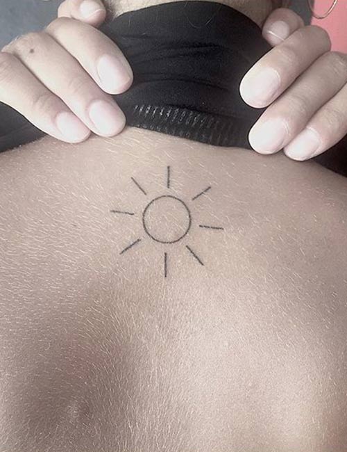 Small Sun tattoo design on back of neck