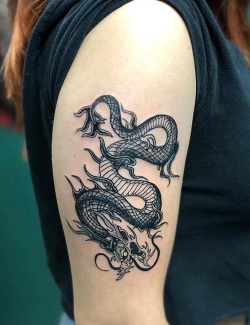 Realistic photo of a dragon tattoo on a man's arm