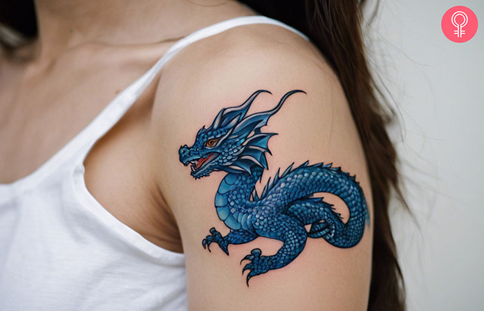 A woman with a blue water dragon tattoo on her upper arm.