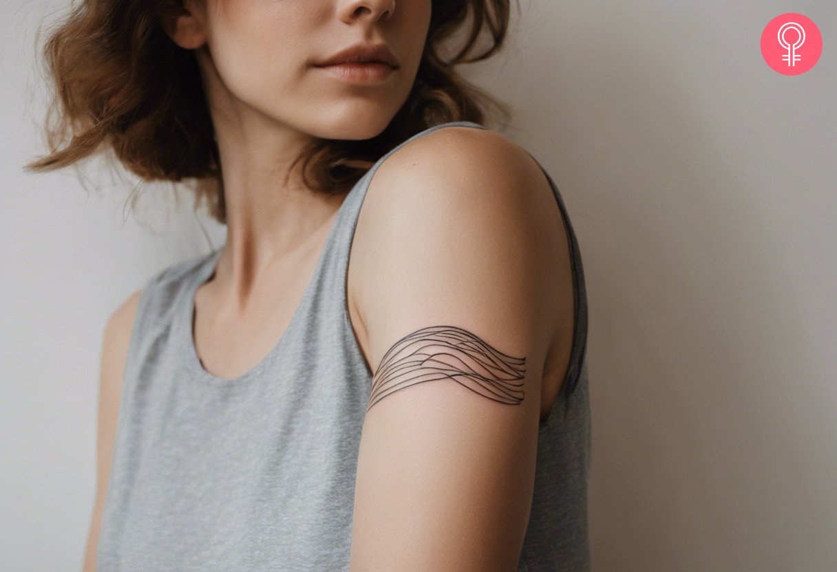 A woman with a wave tattoo on her outer arm